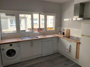 a kitchen with a sink and a washing machine at Apartamento playa sada in Sada +16 photos