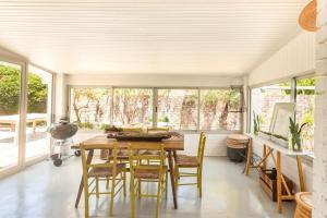 a dining room with a wooden table and chairs at Tranquility in Cape St Francis