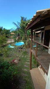 a resort with two swimming pools and a bench at Albacora Eco Residence in Imbassai