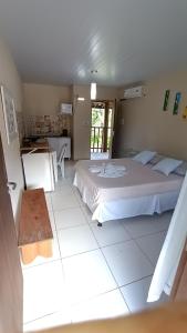 a large bedroom with two beds and a kitchen at Albacora Eco Residence in Imbassai +71 photos