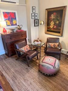 a living room with two chairs and a dresser at Cozy Bohemian Midtown Studio at Minglewood Hall in Memphis