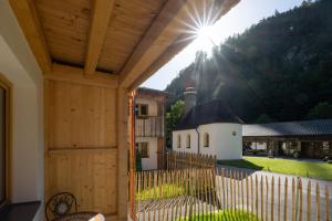 a porch with a wooden fence and a house at Hotel Gasthof Klause Dependance 2 in Reutte