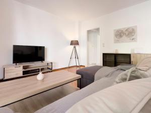 a living room with a tv and a couch at Metamorfoseos Spacious 120sqm apt in Alimos in Athens
