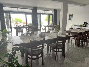 a dining room with tables and chairs and windows at Dela in Hvar