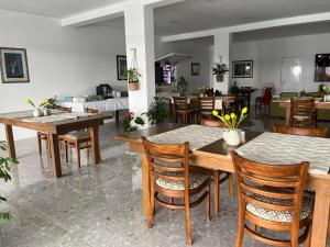 a dining room with wooden tables and chairs at Dela in Hvar