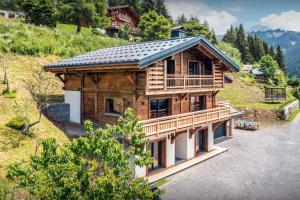 an overhead view of a log house with a roof at Chalet Paralpin - OVO Network in Manigod