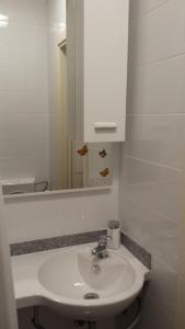 a bathroom with a white sink and a mirror at Studio Apartment Kala in Split