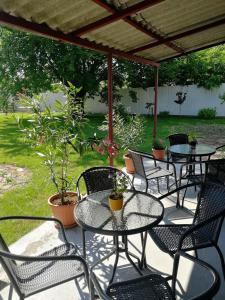 a group of tables and chairs on a patio at Zsuzsanna Vendégház in Gyomaendrőd