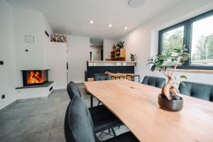 a dining room with a table and a fireplace at Goat's Paradise in Bohinj