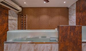 a glass counter in a room with a wall at Treebo Trend Atithi Inn in Mumbai