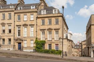 a large brick building on a city street at Newly Renovated City Apartment in Bath