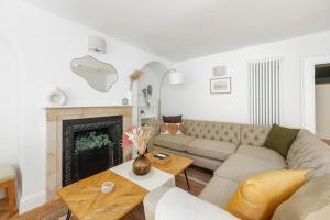 a living room with a couch and a fireplace at Newly Renovated City Apartment in Bath