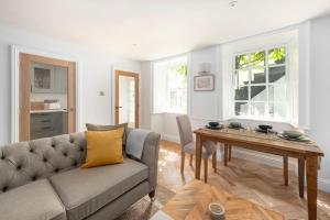 a living room with a couch and a table at Newly Renovated City Apartment in Bath