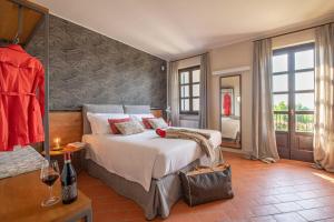 a bedroom with a large bed and a large window at Braida Wine Resort in Rocchetta Tanaro