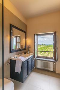 a bathroom with a sink and a window with a view at Braida Wine Resort in Rocchetta Tanaro