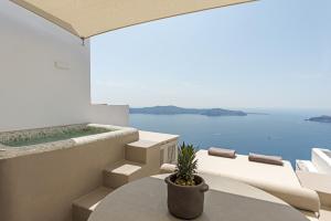 a balcony with a table and a view of the ocean at Seascape Villa by Caldera Houses in Imerovigli