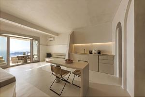 a kitchen with a table and a view of the ocean at Seascape Villa by Caldera Houses in Imerovigli