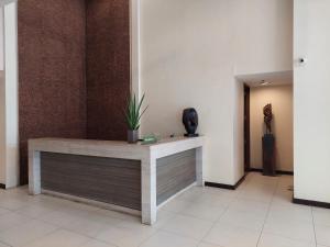 a lobby with a table with a plant on it at Seanna's Place at Pico de Loro in Nasugbu
