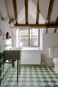 a bathroom with a sink and a toilet at The Cotswold Farm Hideaway in Alderley