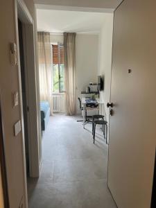 a hallway with a room with a table and a desk at Guesthouse Margherita di Parma in Parma