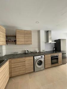a kitchen with a washer and dryer in it at Casa Rosa Nova in Marbella