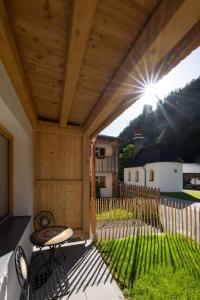 a patio with a table and chairs and a fence at Hotel Gasthof Klause Dependance 2 in Reutte
