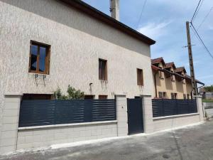 a building with a blue fence on the side of it at La maison de Morgane in Tourmont