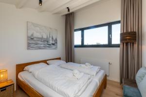 Postel nebo postele na pokoji v ubytování Welcome in - Lepelblad 42, Nieuwvliet