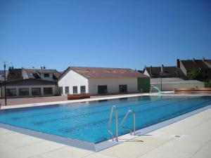 a large swimming pool in front of a house at La maison de Morgane in Tourmont
