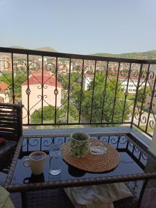 a table with a cup of coffee on a balcony at Apartment in Veles