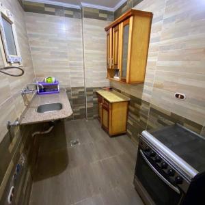 a small kitchen with a sink and a stove at برج دهب قديم in Marsa Matruh