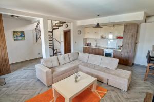 a living room with a couch and a table at Villa Old Olive in Budva