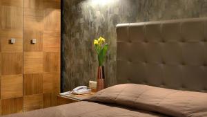 a bedroom with a bed with a vase of flowers at Atrium Hotel Thassos in Potos