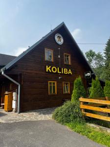 a wooden barn with a sign on the side of it at SKI CIERNY BALOG in Čierny Blh