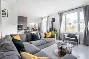 a living room with a couch and a table at Spacious, Modern Home, Central Newquay w/ parking in Newquay