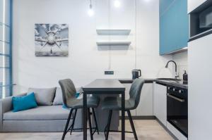 a kitchen with a table and chairs and a couch at 26305 New smart studio in RC Manhattan City in Kyiv