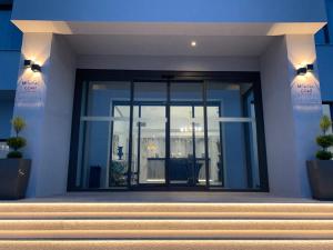 a building with a large glass door on it at Mythical Coast Wellness Retreat in Mytilini
