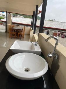 a white sink in a bathroom with a table at KAT RESORT PVT.LTD in Kakani