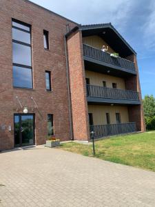 a brick building with a dog on a balcony at Merikotka apartment in Kuressaare