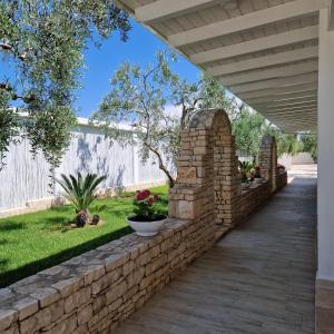 a stone retaining wall in a yard with a walkway at B&B FreeZone in Modugno