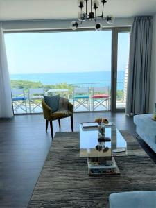 a living room with a couch and a table at Duplex Seaview Condo in Durrës