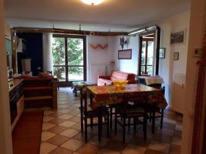 a kitchen and dining room with a table and chairs at Appartamento Presanella in Passo del Tonale