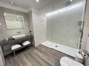 a bathroom with a sink and a shower at RoccaRegina Hotel in Sciacca