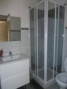 a bathroom with a shower and a sink and a toilet at Blue Sky House in Taormina