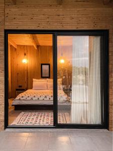 a bedroom with a bed and a sliding glass window at Domain The blaze in Marrakech