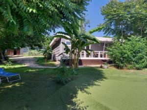 a house with a tree in front of it at SRB Sadovo-Resort-Bulgaria in Sadovo