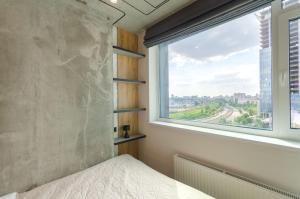 a bedroom with a large window and a bed at 26305 New smart studio in RC Manhattan City in Kyiv