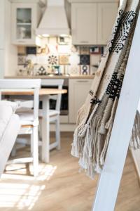 a kitchen with white cabinets and a table at B&B Agramonte in Ispica