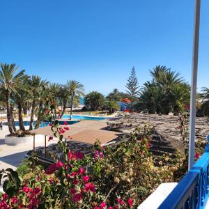 a resort with a swimming pool and flowers at Golf Beach & Thalasso- Families and Couples in Triffa