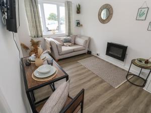 a living room with a couch and a table at 1 Trevelyan in Helston